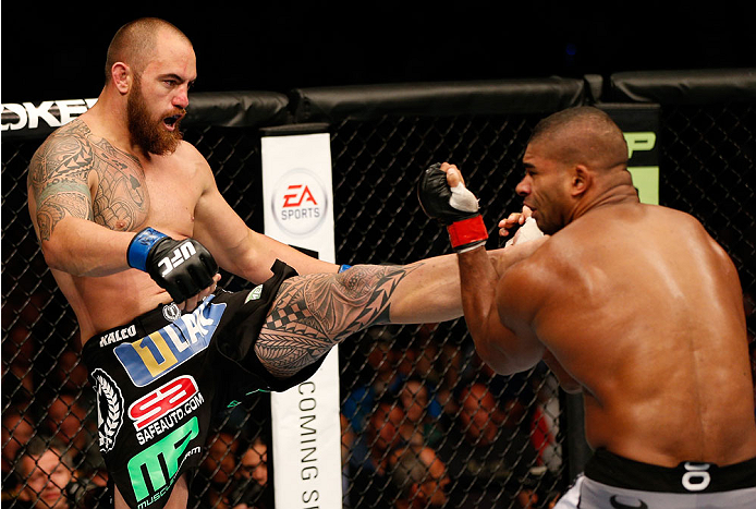 BOSTON, MA - AUGUST 17:  (L-R) Travis Browne knocks down Alistair Overeem with a kick in their UFC heavyweight bout at TD Garden on August 17, 2013 in Boston, Massachusetts. (Photo by Josh Hedges/Zuffa LLC/Zuffa LLC via Getty Images)