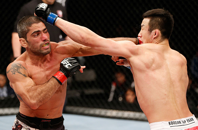 SAITAMA, JAPAN - MARCH 03:  (L-R) Marcelo Guimaraes punches Hyun Gyu Lim in their welterweight fight during the UFC on FUEL TV event at Saitama Super Arena on March 3, 2013 in Saitama, Japan.  (Photo by Josh Hedges/Zuffa LLC/Zuffa LLC via Getty Images)