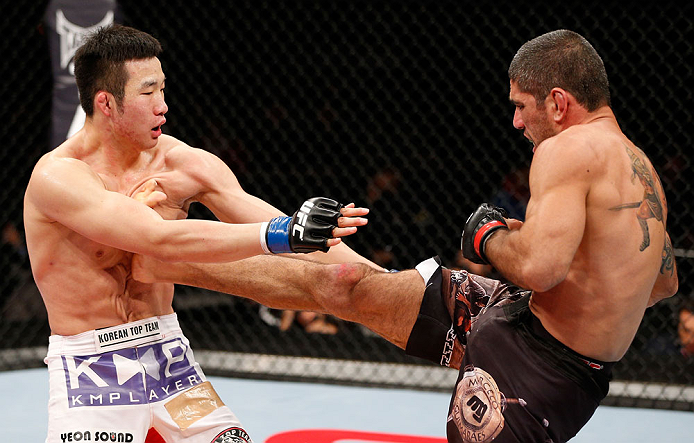 SAITAMA, JAPAN - MARCH 03:  (R-L) Marcelo Guimaraes kicks Hyun Gyu Lim in their welterweight fight during the UFC on FUEL TV event at Saitama Super Arena on March 3, 2013 in Saitama, Japan.  (Photo by Josh Hedges/Zuffa LLC/Zuffa LLC via Getty Images)