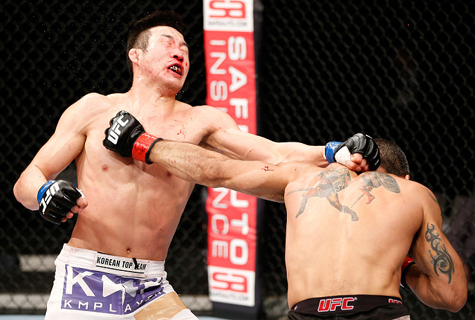 SAITAMA, JAPAN - MARCH 03:  (R-L) Marcelo Guimaraes punches Hyun Gyu Lim in their welterweight fight during the UFC on FUEL TV event at Saitama Super Arena on March 3, 2013 in Saitama, Japan.  (Photo by Josh Hedges/Zuffa LLC/Zuffa LLC via Getty Images)
