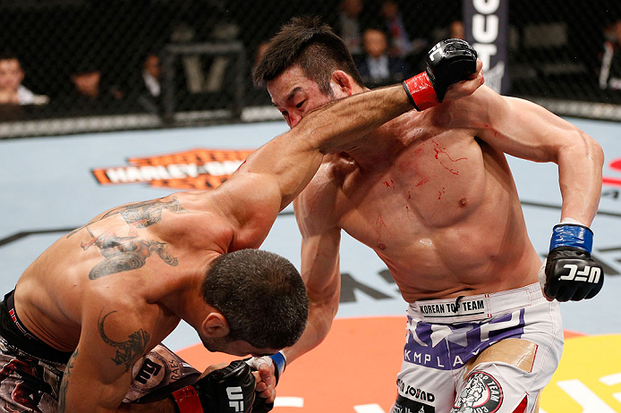 SAITAMA, JAPAN - MARCH 03:  (R-L) Hyun Gyu Lim punches Marcelo Guimaraes in their welterweight fight during the UFC on FUEL TV event at Saitama Super Arena on March 3, 2013 in Saitama, Japan.  (Photo by Josh Hedges/Zuffa LLC/Zuffa LLC via Getty Images)