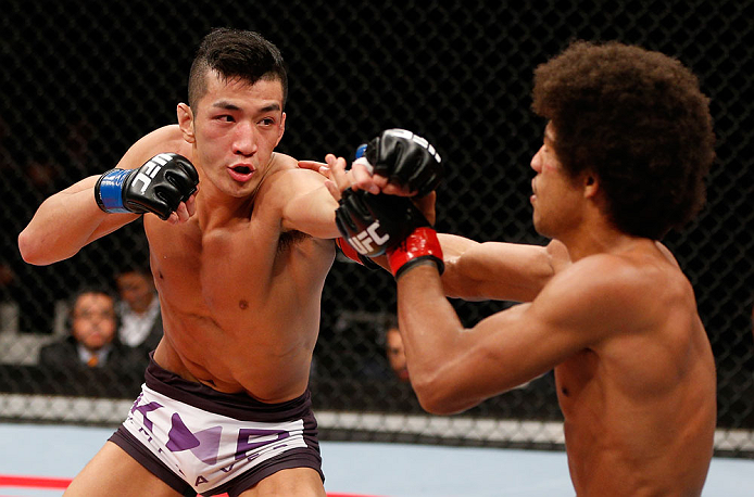 SAITAMA, JAPAN - MARCH 03:  (L-R) Kyung Ho Kang punches Alex Caceres in their bantamweight fight during the UFC on FUEL TV event at Saitama Super Arena on March 3, 2013 in Saitama, Japan.  (Photo by Josh Hedges/Zuffa LLC/Zuffa LLC via Getty Images)