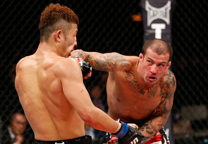 SAITAMA, JAPAN - MARCH 03:  (R-L) Cristiano Marcello punches Kazuki Tokudome in their lightweight fight during the UFC on FUEL TV event at Saitama Super Arena on March 3, 2013 in Saitama, Japan.  (Photo by Josh Hedges/Zuffa LLC/Zuffa LLC via Getty Images)