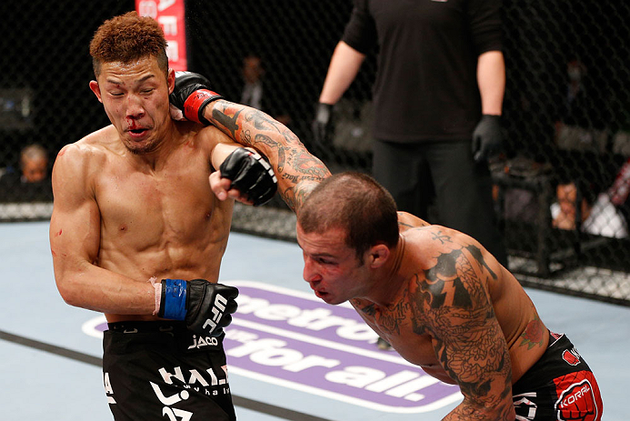 SAITAMA, JAPAN - MARCH 03:  (R-L) Cristiano Marcello punches Kazuki Tokudome in their lightweight fight during the UFC on FUEL TV event at Saitama Super Arena on March 3, 2013 in Saitama, Japan.  (Photo by Josh Hedges/Zuffa LLC/Zuffa LLC via Getty Images)