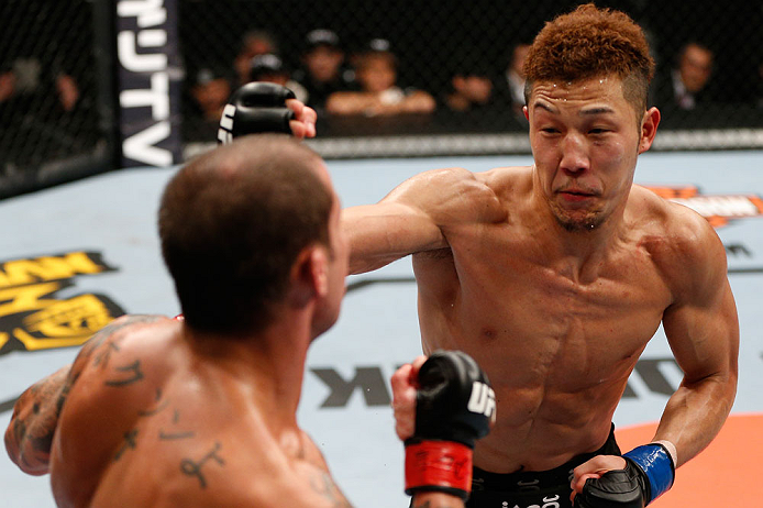 SAITAMA, JAPAN - MARCH 03:  (R-L) Kazuki Tokudome punches Cristiano Marcello in their lightweight fight during the UFC on FUEL TV event at Saitama Super Arena on March 3, 2013 in Saitama, Japan.  (Photo by Josh Hedges/Zuffa LLC/Zuffa LLC via Getty Images)