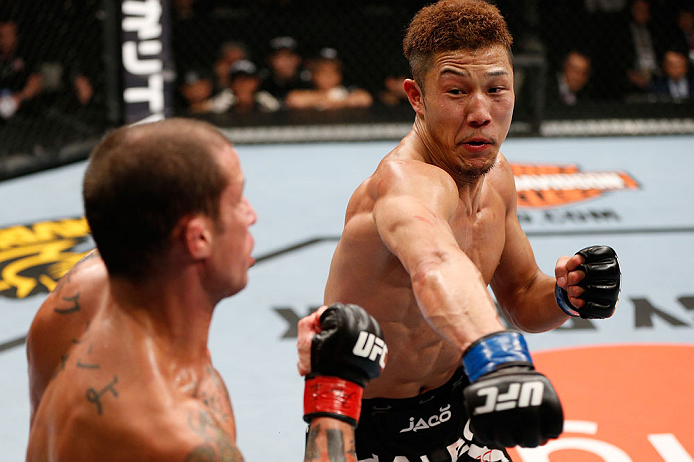 SAITAMA, JAPAN - MARCH 03:  (R-L) Kazuki Tokudome punches Cristiano Marcello in their lightweight fight during the UFC on FUEL TV event at Saitama Super Arena on March 3, 2013 in Saitama, Japan.  (Photo by Josh Hedges/Zuffa LLC/Zuffa LLC via Getty Images)