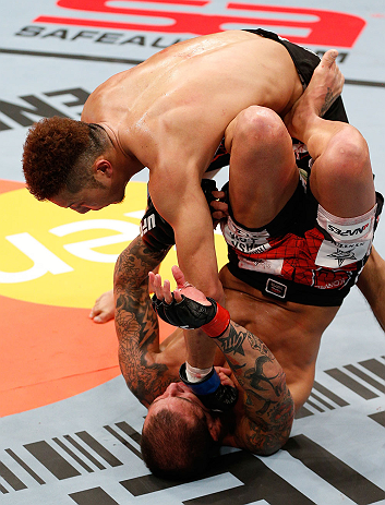 SAITAMA, JAPAN - MARCH 03:  Kazuki Tokudome (top) punches Cristiano Marcello in their lightweight fight during the UFC on FUEL TV event at Saitama Super Arena on March 3, 2013 in Saitama, Japan.  (Photo by Josh Hedges/Zuffa LLC/Zuffa LLC via Getty Images)