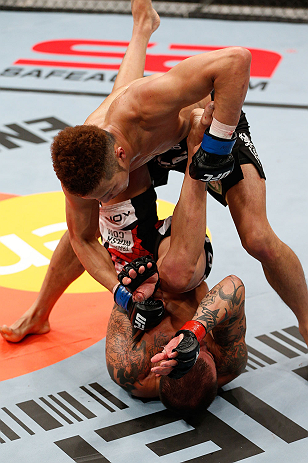 SAITAMA, JAPAN - MARCH 03:  Kazuki Tokudome (top) punches Cristiano Marcello in their lightweight fight during the UFC on FUEL TV event at Saitama Super Arena on March 3, 2013 in Saitama, Japan.  (Photo by Josh Hedges/Zuffa LLC/Zuffa LLC via Getty Images)