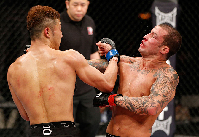 SAITAMA, JAPAN - MARCH 03:  (L-R) Kazuki Tokudome punches Cristiano Marcello in their lightweight fight during the UFC on FUEL TV event at Saitama Super Arena on March 3, 2013 in Saitama, Japan.  (Photo by Josh Hedges/Zuffa LLC/Zuffa LLC via Getty Images)