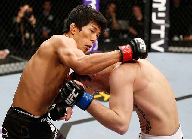 SAITAMA, JAPAN - MARCH 03:  (L-R) Takeya Mizugaki punches Bryan Caraway in their bantamweight fight during the UFC on FUEL TV event at Saitama Super Arena on March 3, 2013 in Saitama, Japan.  (Photo by Josh Hedges/Zuffa LLC/Zuffa LLC via Getty Images)