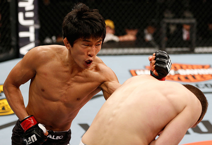 SAITAMA, JAPAN - MARCH 03:  (L-R) Takeya Mizugaki punches Bryan Caraway in their bantamweight fight during the UFC on FUEL TV event at Saitama Super Arena on March 3, 2013 in Saitama, Japan.  (Photo by Josh Hedges/Zuffa LLC/Zuffa LLC via Getty Images)