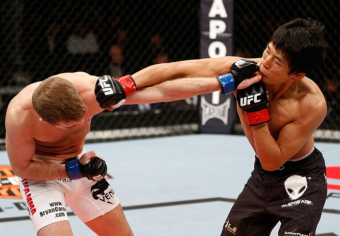 SAITAMA, JAPAN - MARCH 03:  (R-L) Takeya Mizugaki and Bryan Caraway trade punches in their bantamweight fight during the UFC on FUEL TV event at Saitama Super Arena on March 3, 2013 in Saitama, Japan.  (Photo by Josh Hedges/Zuffa LLC/Zuffa LLC via Getty Images)