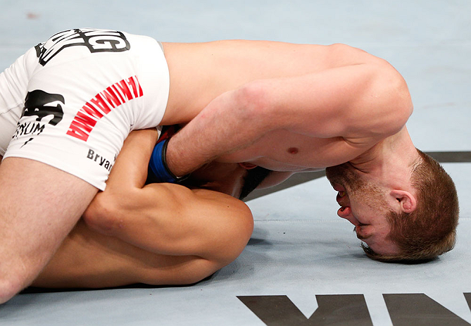SAITAMA, JAPAN - MARCH 03:  Bryan Caraway (top) attempts to submit Takeya Mizugaki with a guillotine choke in their bantamweight fight during the UFC on FUEL TV event at Saitama Super Arena on March 3, 2013 in Saitama, Japan.  (Photo by Josh Hedges/Zuffa LLC/Zuffa LLC via Getty Images)