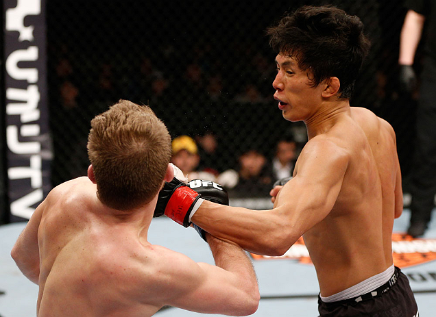 SAITAMA, JAPAN - MARCH 03:  (R-L) Takeya Mizugaki punches Bryan Caraway in their bantamweight fight during the UFC on FUEL TV event at Saitama Super Arena on March 3, 2013 in Saitama, Japan.  (Photo by Josh Hedges/Zuffa LLC/Zuffa LLC via Getty Images)