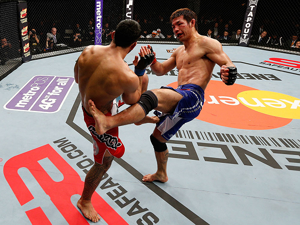 SAITAMA, JAPAN - MARCH 03:  (R-L) Riki Fukuda kicks Brad Tavares in their middleweight fight during the UFC on FUEL TV event at Saitama Super Arena on March 3, 2013 in Saitama, Japan.  (Photo by Josh Hedges/Zuffa LLC/Zuffa LLC via Getty Images)