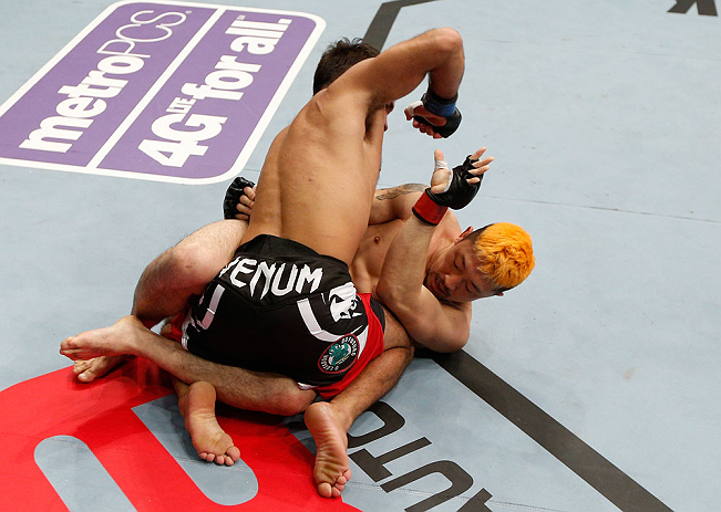 SAITAMA, JAPAN - MARCH 03:  (L-R) Rani Yahya punches Mizuto Hirota in their featherweight fight during the UFC on FUEL TV event at Saitama Super Arena on March 3, 2013 in Saitama, Japan.  (Photo by Josh Hedges/Zuffa LLC/Zuffa LLC via Getty Images)