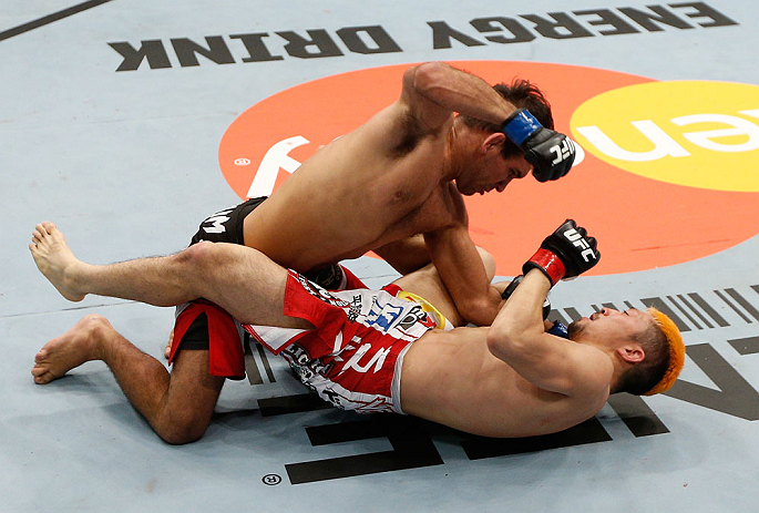 SAITAMA, JAPAN - MARCH 03:  (L-R) Rani Yahya punches Mizuto Hirota in their featherweight fight during the UFC on FUEL TV event at Saitama Super Arena on March 3, 2013 in Saitama, Japan.  (Photo by Josh Hedges/Zuffa LLC/Zuffa LLC via Getty Images)