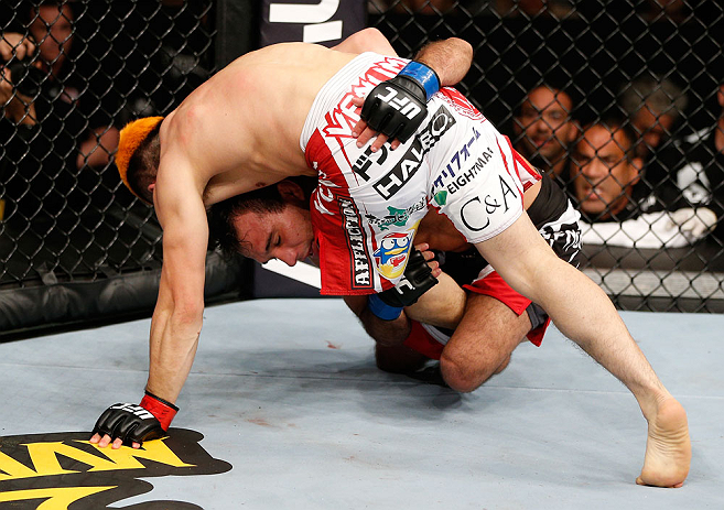 SAITAMA, JAPAN - MARCH 03:  (R-L) Rani Yahya takes down Mizuto Hirota in their featherweight fight during the UFC on FUEL TV event at Saitama Super Arena on March 3, 2013 in Saitama, Japan.  (Photo by Josh Hedges/Zuffa LLC/Zuffa LLC via Getty Images)