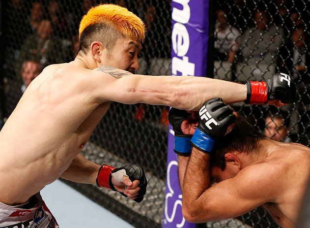 SAITAMA, JAPAN - MARCH 03:  (L-R) Mizuto Hirota punches Rani Yahya in their featherweight fight during the UFC on FUEL TV event at Saitama Super Arena on March 3, 2013 in Saitama, Japan.  (Photo by Josh Hedges/Zuffa LLC/Zuffa LLC via Getty Images)