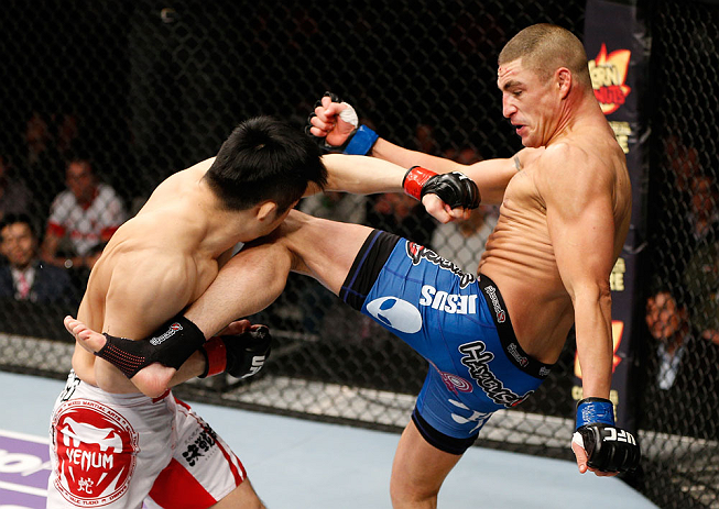 SAITAMA, JAPAN - MARCH 03:  (R-L) Diego Sanchez kicks Takanori Gomi in their lightweight fight during the UFC on FUEL TV event at Saitama Super Arena on March 3, 2013 in Saitama, Japan.  (Photo by Josh Hedges/Zuffa LLC/Zuffa LLC via Getty Images)