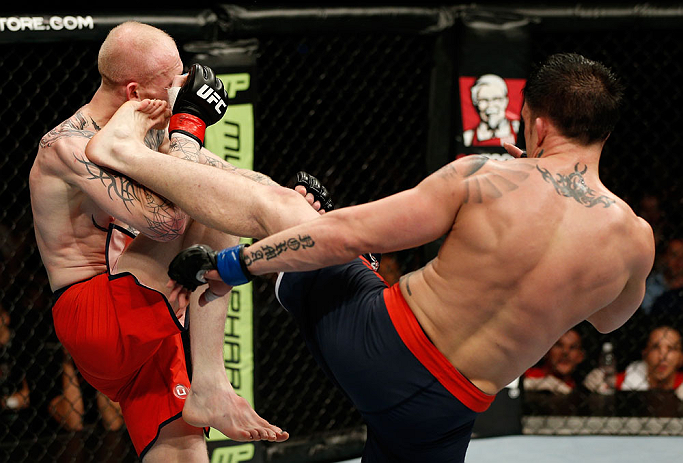 GOLD COAST, AUSTRALIA - DECEMBER 15:  (R-L) Norman Parke kicks Colin Fletcher during their lightweight fight at the UFC on FX event on December 15, 2012  at Gold Coast Convention and Exhibition Centre in Gold Coast, Australia.  (Photo by Josh Hedges/Zuffa LLC/Zuffa LLC via Getty Images)