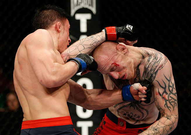 GOLD COAST, AUSTRALIA - DECEMBER 15:  (L-R) Norman Parke punches Colin Fletcher during their lightweight fight at the UFC on FX event on December 15, 2012  at Gold Coast Convention and Exhibition Centre in Gold Coast, Australia.  (Photo by Josh Hedges/Zuffa LLC/Zuffa LLC via Getty Images)