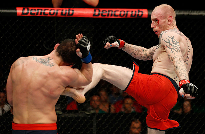 GOLD COAST, AUSTRALIA - DECEMBER 15:  (R-L) Colin Fletcher kicks Norman Parke during their lightweight fight at the UFC on FX event on December 15, 2012  at Gold Coast Convention and Exhibition Centre in Gold Coast, Australia.  (Photo by Josh Hedges/Zuffa LLC/Zuffa LLC via Getty Images)