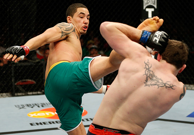 GOLD COAST, AUSTRALIA - DECEMBER 15:  (L-R) Robert Whittaker kicks Bradley Scott during their welterweight fight at the UFC on FX event on December 15, 2012  at Gold Coast Convention and Exhibition Centre in Gold Coast, Australia.  (Photo by Josh Hedges/Zuffa LLC/Zuffa LLC via Getty Images)