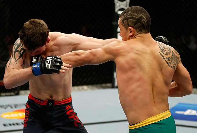 GOLD COAST, AUSTRALIA - DECEMBER 15:  (R-L) Robert Whittaker punches Bradley Scott during their welterweight fight at the UFC on FX event on December 15, 2012  at Gold Coast Convention and Exhibition Centre in Gold Coast, Australia.  (Photo by Josh Hedges/Zuffa LLC/Zuffa LLC via Getty Images)