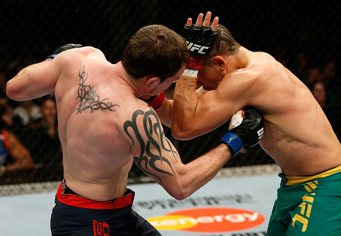 GOLD COAST, AUSTRALIA - DECEMBER 15:  (L-R) Bradley Scott punches Robert Whittaker during their welterweight fight at the UFC on FX event on December 15, 2012  at Gold Coast Convention and Exhibition Centre in Gold Coast, Australia.  (Photo by Josh Hedges/Zuffa LLC/Zuffa LLC via Getty Images)
