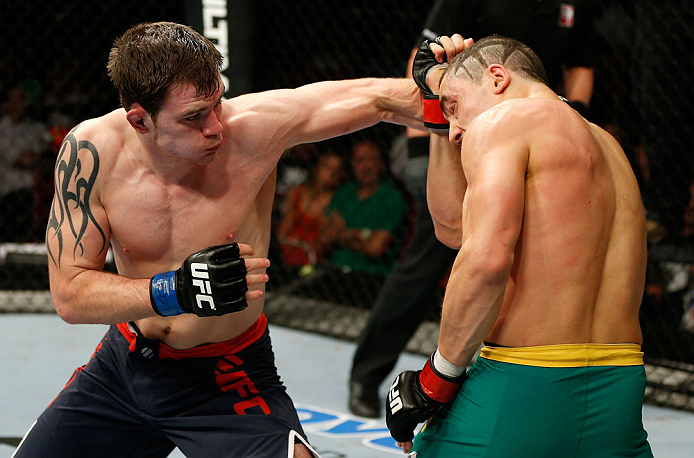 GOLD COAST, AUSTRALIA - DECEMBER 15:  (L-R) Bradley Scott punches Robert Whittaker during their welterweight fight at the UFC on FX event on December 15, 2012  at Gold Coast Convention and Exhibition Centre in Gold Coast, Australia.  (Photo by Josh Hedges/Zuffa LLC/Zuffa LLC via Getty Images)