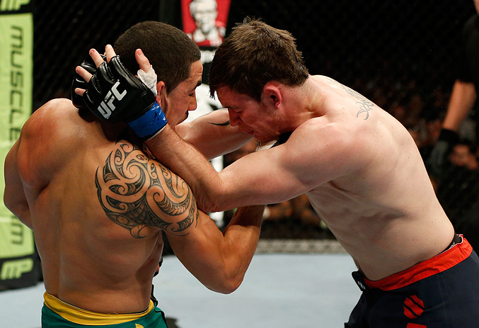 GOLD COAST, AUSTRALIA - DECEMBER 15:  (L-R) Robert Whittaker punches Bradley Scott during their welterweight fight at the UFC on FX event on December 15, 2012  at Gold Coast Convention and Exhibition Centre in Gold Coast, Australia.  (Photo by Josh Hedges/Zuffa LLC/Zuffa LLC via Getty Images)