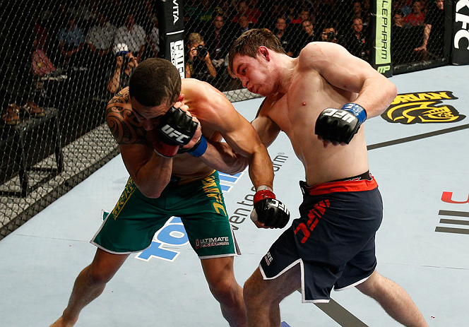 GOLD COAST, AUSTRALIA - DECEMBER 15:  (R-L) Bradley Scott punches Robert Whittaker during their welterweight fight at the UFC on FX event on December 15, 2012  at Gold Coast Convention and Exhibition Centre in Gold Coast, Australia.  (Photo by Josh Hedges/Zuffa LLC/Zuffa LLC via Getty Images)