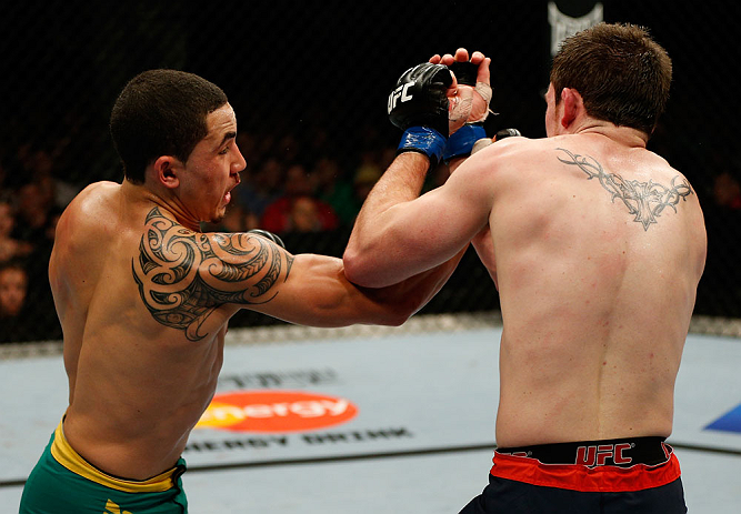 GOLD COAST, AUSTRALIA - DECEMBER 15:  (L-R) Robert Whittaker punches Bradley Scott during their welterweight fight at the UFC on FX event on December 15, 2012  at Gold Coast Convention and Exhibition Centre in Gold Coast, Australia.  (Photo by Josh Hedges/Zuffa LLC/Zuffa LLC via Getty Images)