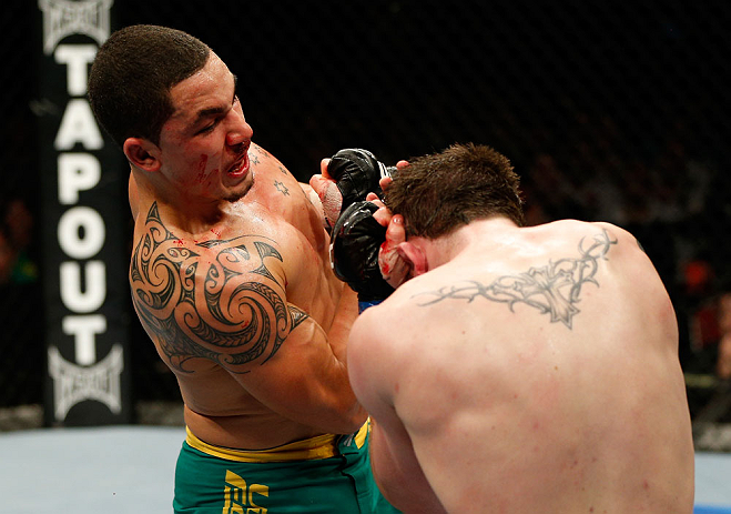 GOLD COAST, AUSTRALIA - DECEMBER 15:  (L-R) Robert Whittaker punches Bradley Scott during their welterweight fight at the UFC on FX event on December 15, 2012  at Gold Coast Convention and Exhibition Centre in Gold Coast, Australia.  (Photo by Josh Hedges/Zuffa LLC/Zuffa LLC via Getty Images)
