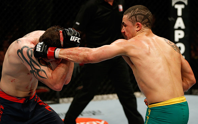 GOLD COAST, AUSTRALIA - DECEMBER 15:  (R-L) Robert Whittaker punches Bradley Scott during their welterweight fight at the UFC on FX event on December 15, 2012  at Gold Coast Convention and Exhibition Centre in Gold Coast, Australia.  (Photo by Josh Hedges/Zuffa LLC/Zuffa LLC via Getty Images)