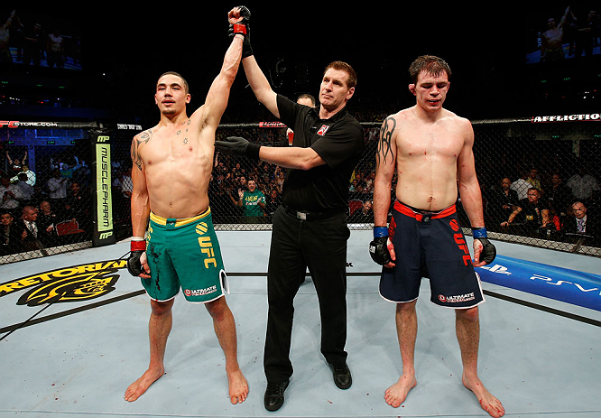 GOLD COAST, AUSTRALIA - DECEMBER 15:  Robert Whittaker (L) reacts after defeating Bradley Scott during their welterweight fight at the UFC on FX event on December 15, 2012  at Gold Coast Convention and Exhibition Centre in Gold Coast, Australia.  (Photo by Josh Hedges/Zuffa LLC/Zuffa LLC via Getty Images)