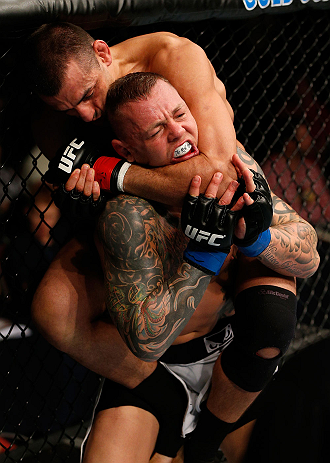 GOLD COAST, AUSTRALIA - DECEMBER 15:  (L-R) George Sotiropoulos attempts a rear choke against Ross Pearson during their lightweight fight at the UFC on FX event on December 15, 2012  at Gold Coast Convention and Exhibition Centre in Gold Coast, Australia.  (Photo by Josh Hedges/Zuffa LLC/Zuffa LLC via Getty Images)