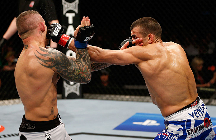 GOLD COAST, AUSTRALIA - DECEMBER 15:  (R-L) George Sotiropoulos punches Ross Pearson during their lightweight fight at the UFC on FX event on December 15, 2012  at Gold Coast Convention and Exhibition Centre in Gold Coast, Australia.  (Photo by Josh Hedges/Zuffa LLC/Zuffa LLC via Getty Images)