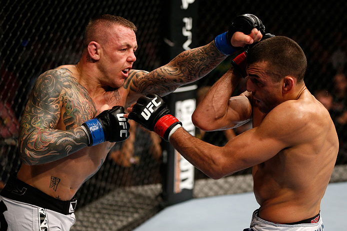 GOLD COAST, AUSTRALIA - DECEMBER 15:  (L-R) Ross Pearson punches George Sotiropoulos during their lightweight fight at the UFC on FX event on December 15, 2012  at Gold Coast Convention and Exhibition Centre in Gold Coast, Australia.  (Photo by Josh Hedges/Zuffa LLC/Zuffa LLC via Getty Images)