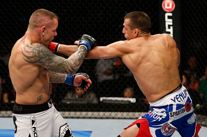 GOLD COAST, AUSTRALIA - DECEMBER 15:  (R-L) George Sotiropoulos punches Ross Pearson during their lightweight fight at the UFC on FX event on December 15, 2012  at Gold Coast Convention and Exhibition Centre in Gold Coast, Australia.  (Photo by Josh Hedges/Zuffa LLC/Zuffa LLC via Getty Images)