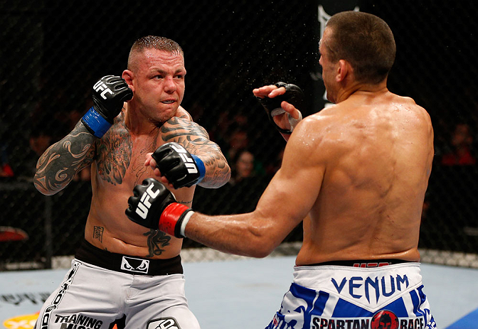 GOLD COAST, AUSTRALIA - DECEMBER 15:  (L-R) Ross Pearson punches George Sotiropoulos during their lightweight fight at the UFC on FX event on December 15, 2012  at Gold Coast Convention and Exhibition Centre in Gold Coast, Australia.  (Photo by Josh Hedges/Zuffa LLC/Zuffa LLC via Getty Images)