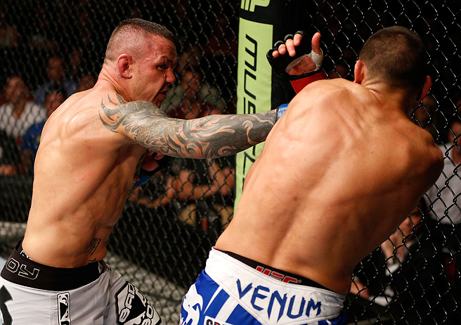 GOLD COAST, AUSTRALIA - DECEMBER 15:  (L-R) Ross Pearson punches George Sotiropoulos during their lightweight fight at the UFC on FX event on December 15, 2012  at Gold Coast Convention and Exhibition Centre in Gold Coast, Australia.  (Photo by Josh Hedges/Zuffa LLC/Zuffa LLC via Getty Images)