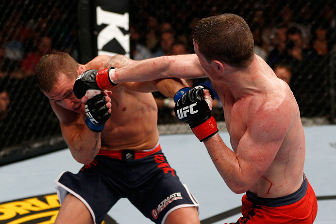 GOLD COAST, AUSTRALIA - DECEMBER 15:  (R-L) Brendan Loughnan punches Mike Wilkinson during their lightweight fight at the UFC on FX event on December 15, 2012  at Gold Coast Convention and Exhibition Centre in Gold Coast, Australia.  (Photo by Josh Hedges/Zuffa LLC/Zuffa LLC via Getty Images)
