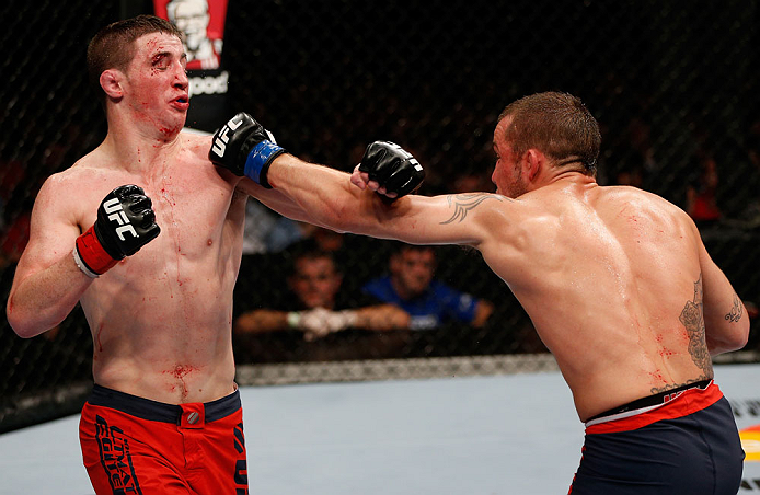 GOLD COAST, AUSTRALIA - DECEMBER 15:  (R-L) Mike Wilkinson punches Brendan Loughnane during their lightweight fight at the UFC on FX event on December 15, 2012  at Gold Coast Convention and Exhibition Centre in Gold Coast, Australia.  (Photo by Josh Hedges/Zuffa LLC/Zuffa LLC via Getty Images)