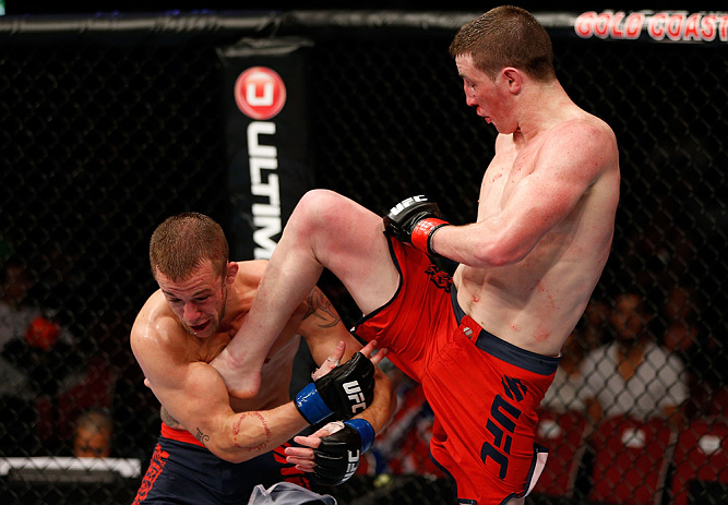 GOLD COAST, AUSTRALIA - DECEMBER 15:  (R-L) Brendan Loughnane delivers a flying knee against Mike Wilkinson during their lightweight fight at the UFC on FX event on December 15, 2012  at Gold Coast Convention and Exhibition Centre in Gold Coast, Australia.  (Photo by Josh Hedges/Zuffa LLC/Zuffa LLC via Getty Images)