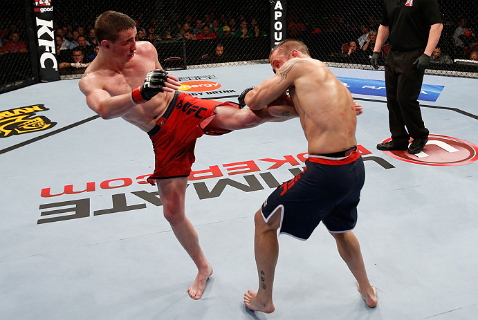 GOLD COAST, AUSTRALIA - DECEMBER 15:  (L-R) Brendan Loughnane kicks Mike Wilkinson during their lightweight fight at the UFC on FX event on December 15, 2012  at Gold Coast Convention and Exhibition Centre in Gold Coast, Australia.  (Photo by Josh Hedges/Zuffa LLC/Zuffa LLC via Getty Images)