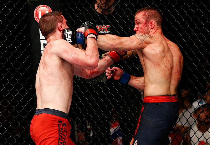 GOLD COAST, AUSTRALIA - DECEMBER 15:  (R-L) Mike Wilkinson punches Brendan Loughnane during their lightweight fight at the UFC on FX event on December 15, 2012  at Gold Coast Convention and Exhibition Centre in Gold Coast, Australia.  (Photo by Josh Hedges/Zuffa LLC/Zuffa LLC via Getty Images)