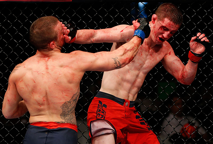 GOLD COAST, AUSTRALIA - DECEMBER 15:  (L-R) Mike Wilkinson punches Brendan Loughnane during their lightweight fight at the UFC on FX event on December 15, 2012  at Gold Coast Convention and Exhibition Centre in Gold Coast, Australia.  (Photo by Josh Hedges/Zuffa LLC/Zuffa LLC via Getty Images)