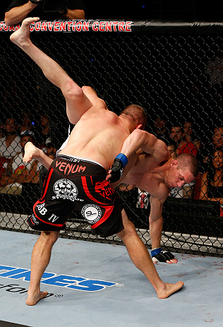 GOLD COAST, AUSTRALIA - DECEMBER 15:  (L-R) Mike Pierce takes down Seth Baczynski during their welterweight fight at the UFC on FX event on December 15, 2012  at Gold Coast Convention and Exhibition Centre in Gold Coast, Australia.  (Photo by Josh Hedges/Zuffa LLC/Zuffa LLC via Getty Images)